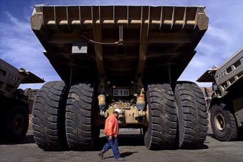 A human walks behind a Self Driving Truck at Rio Tinto Mine Australia Google Images CCL